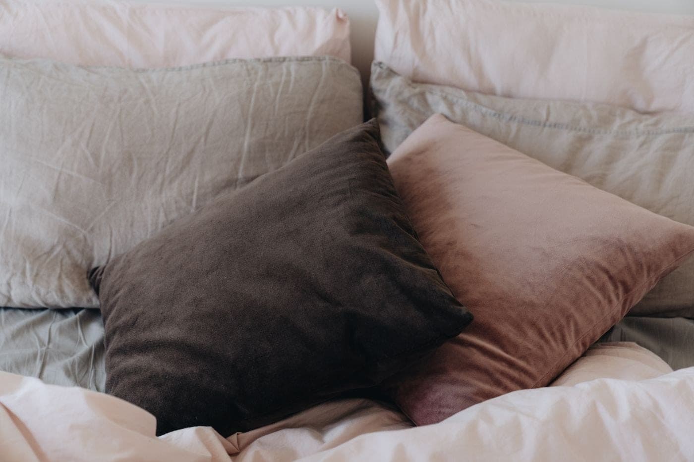 Premium bed linen styled with soft pillows and a draped duvet