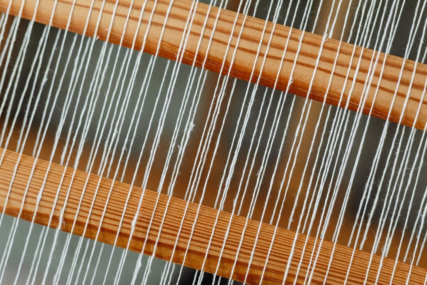 Cloth being woven by hand on a traditional wooden loom