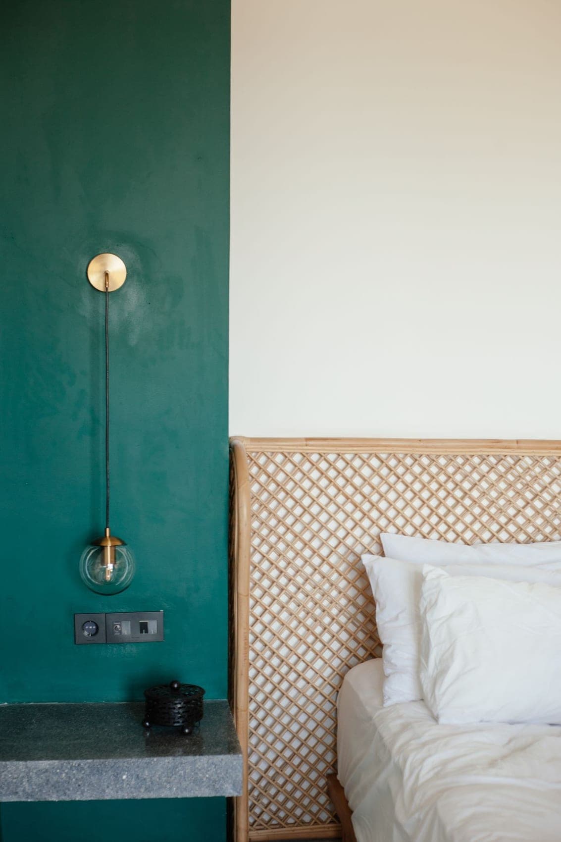 An elegant bedroom styled with home textiles in brand-green tones