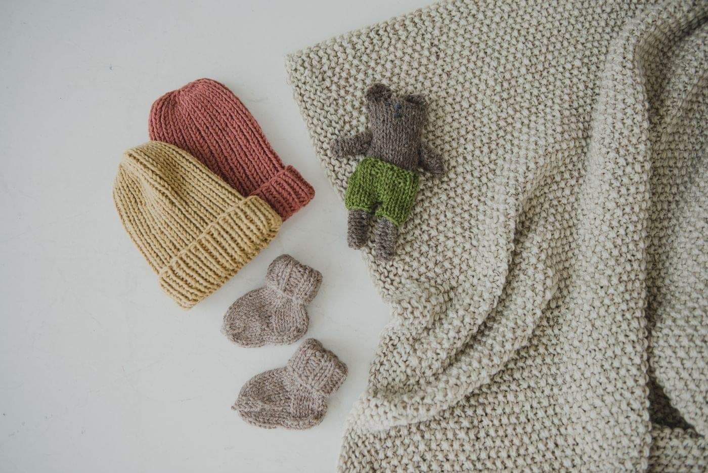 Soft knitted beanies and socks in neutral tones