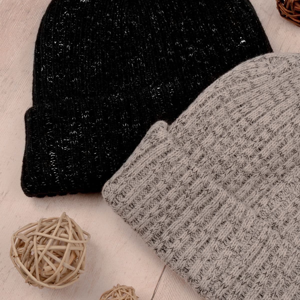 Black and grey knit beanies in a flat-lay