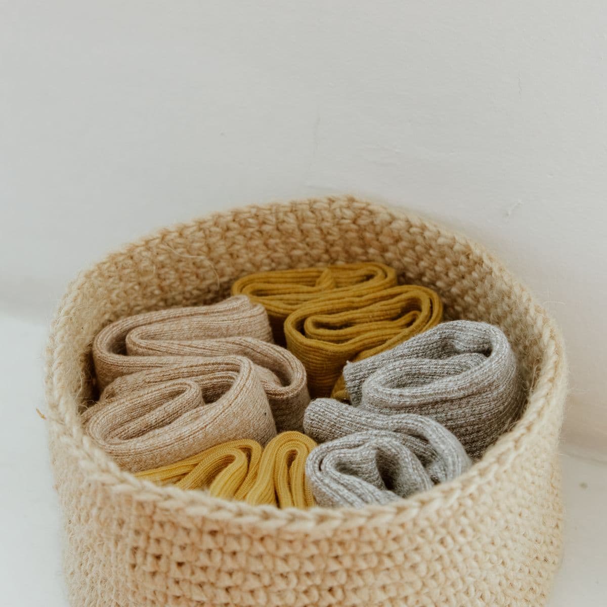 Rolled knit socks in a woven basket