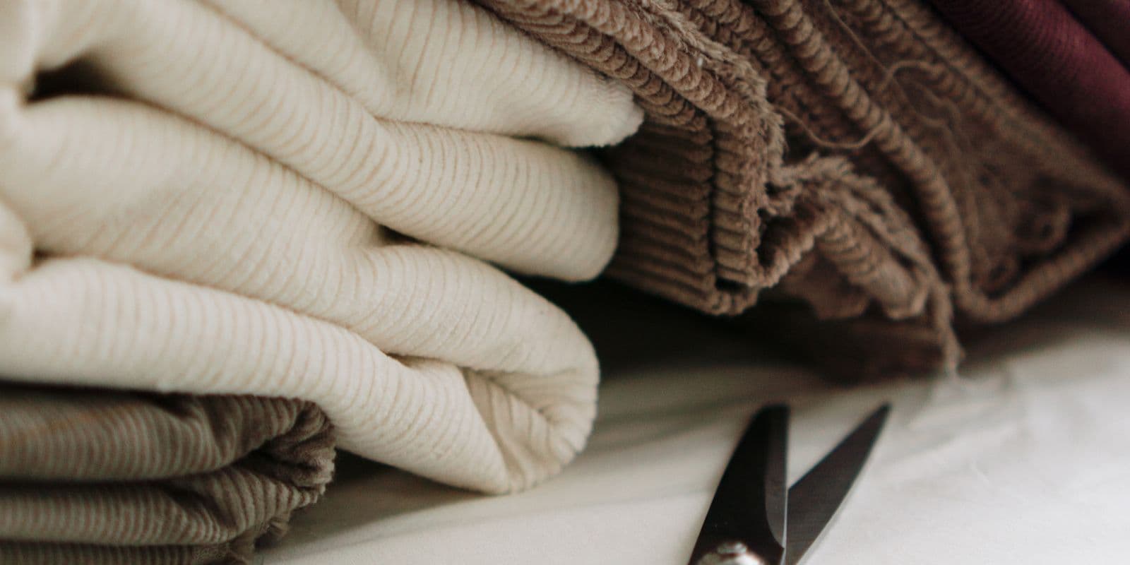 Neatly folded corduroy fabrics in ivory and camel