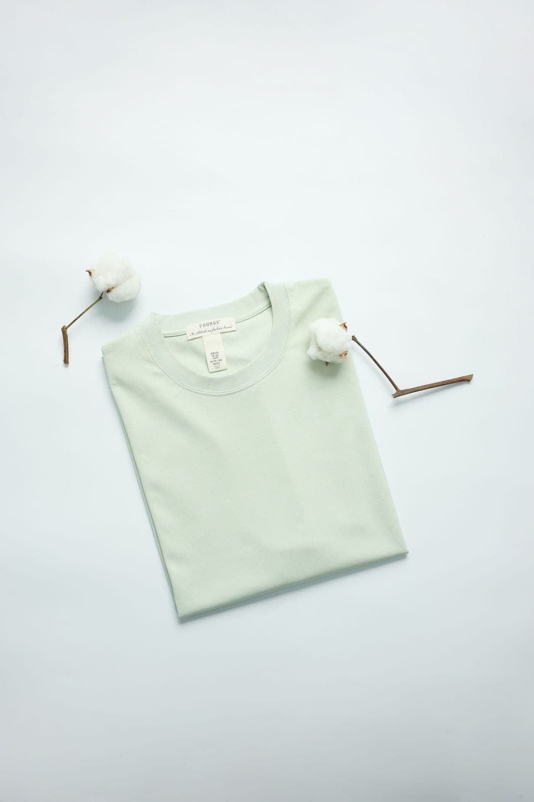 A soft mint t-shirt styled with cotton stems