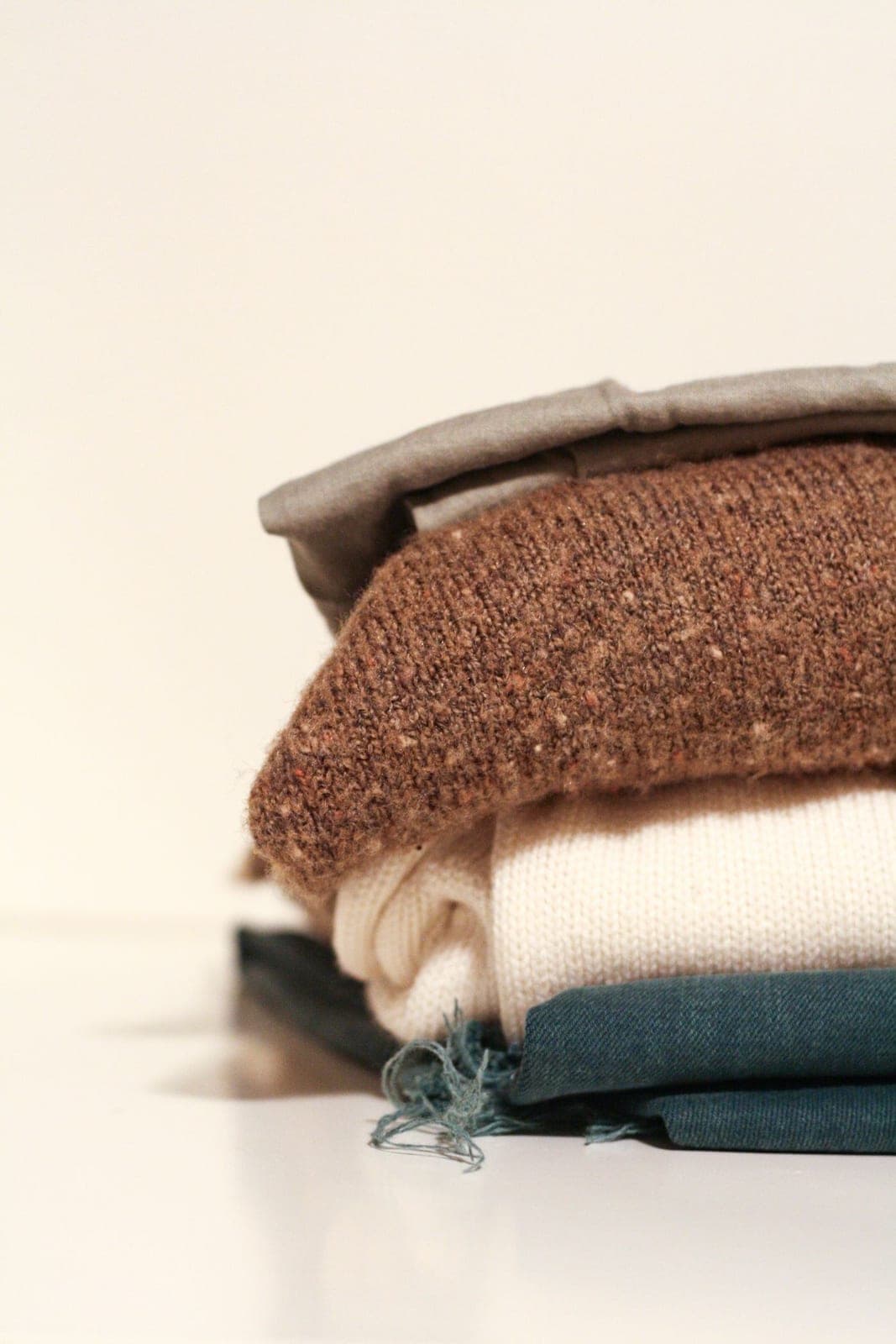 A folded stack of knitted sweaters