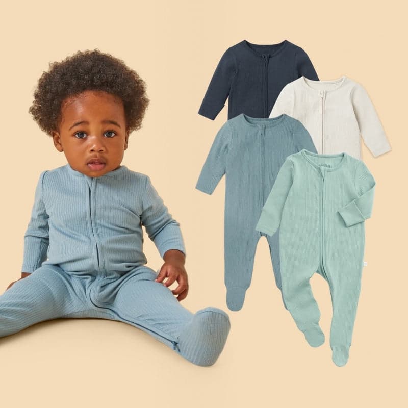 A set of ribbed baby sleepsuits in soft tones