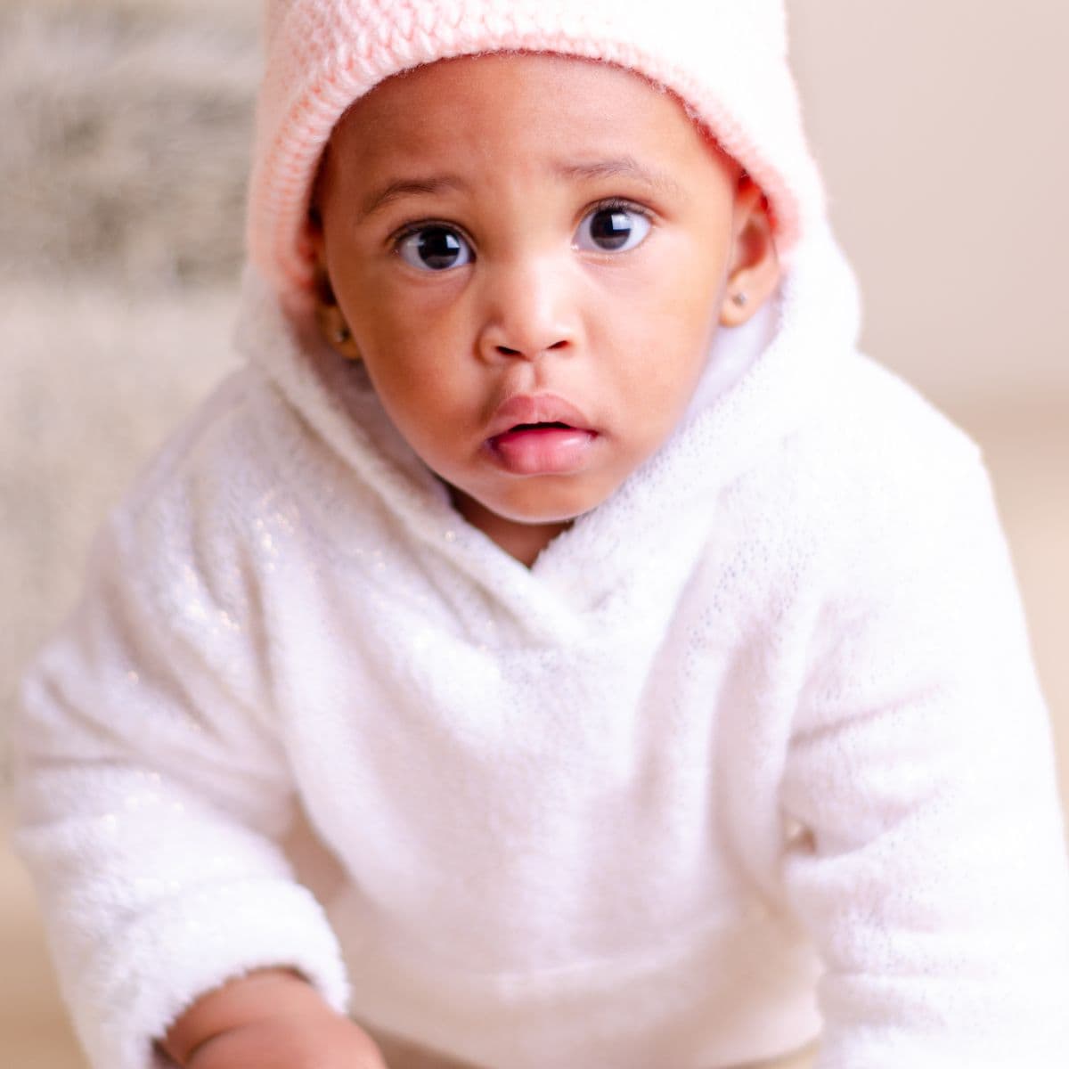 Baby in a white hooded top