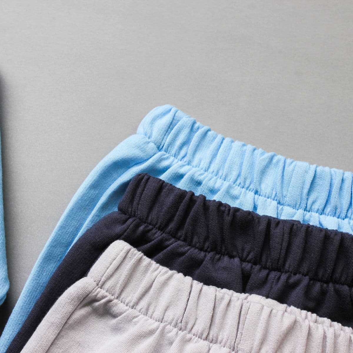 Folded baby leggings in soft blue, navy and cream