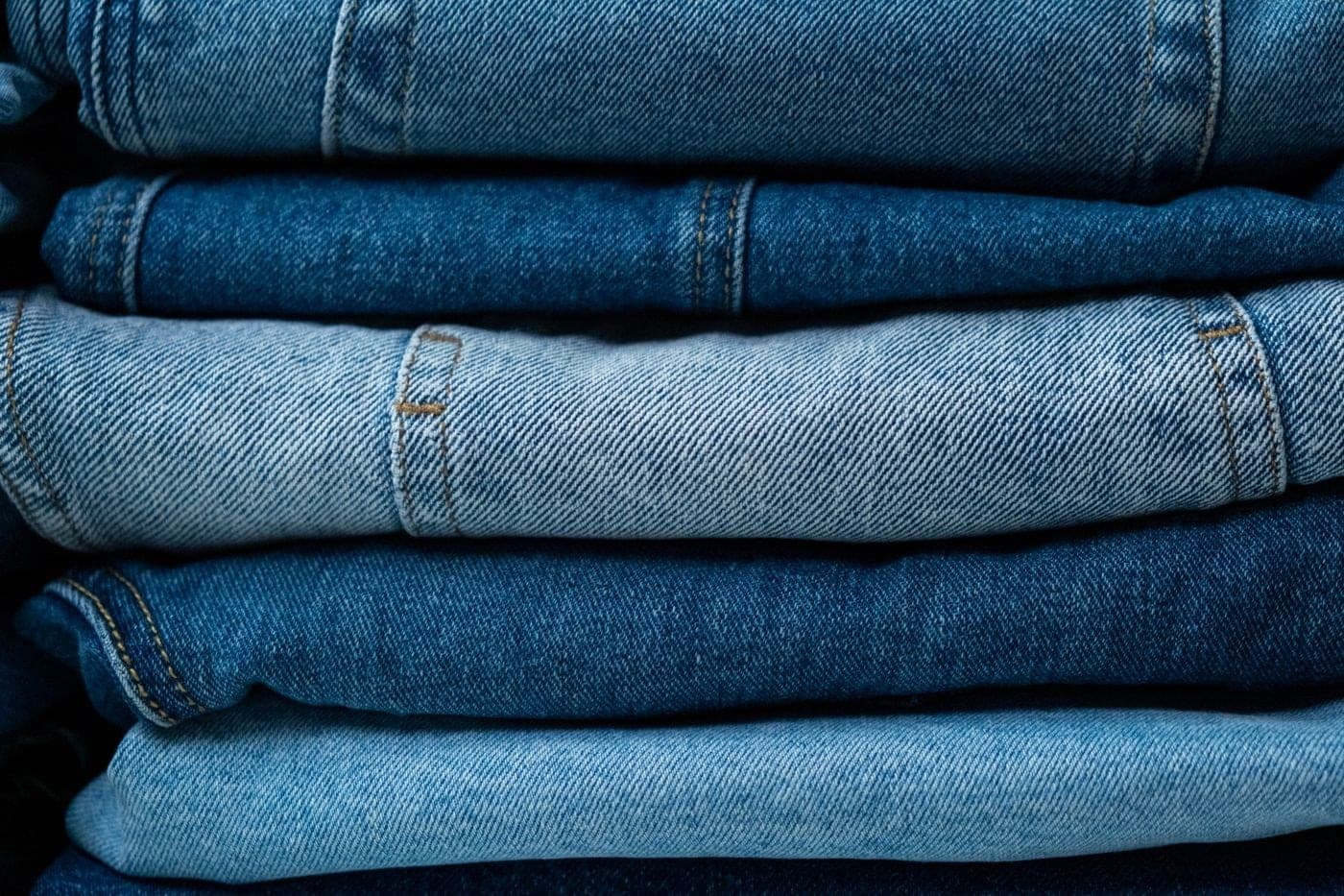A neat stack of folded light-blue jeans