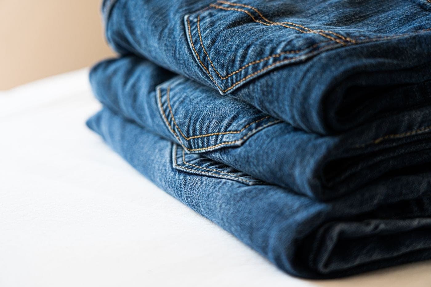 Close detail of folded jeans and pocket stitching