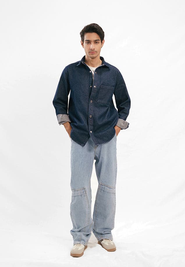 Male model in a relaxed-fit raw blue denim shirt