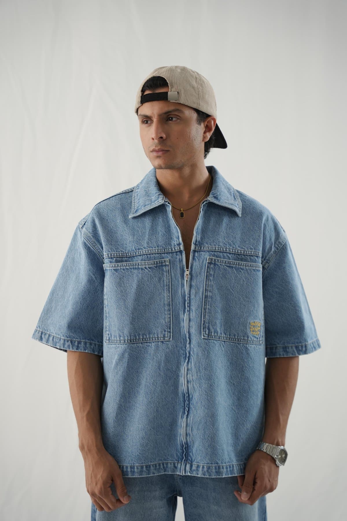 Male model in a boxy washed-out blue denim shirt
