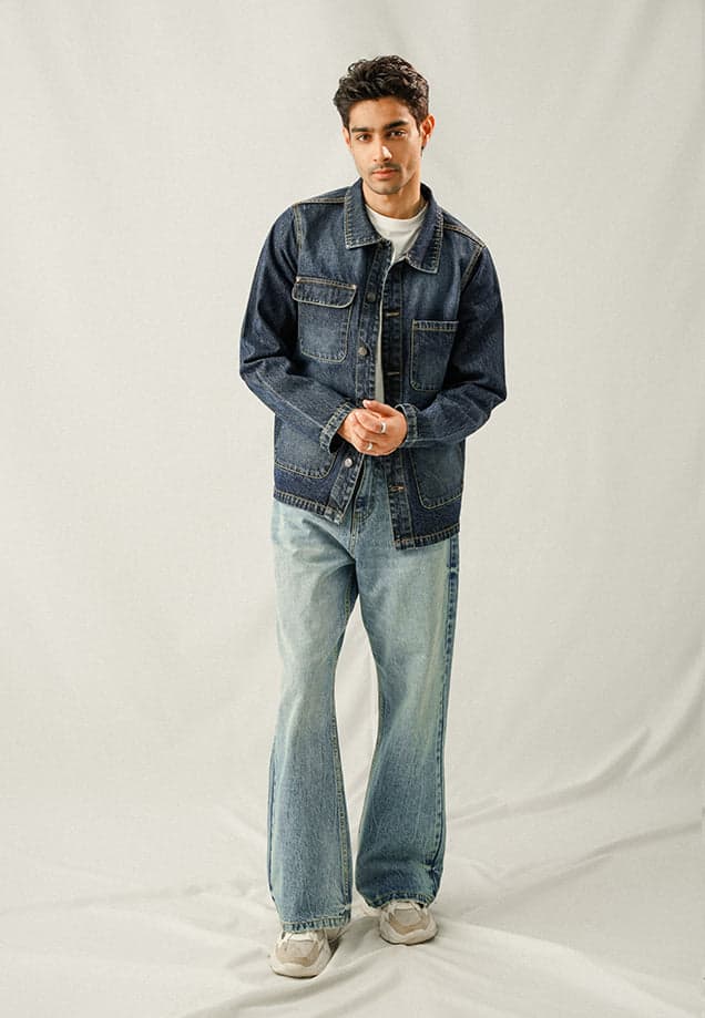 Male model in a washed-blue multi-pocket denim over shirt
