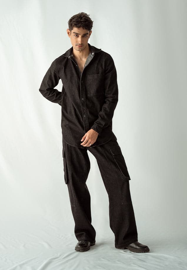 Male model in a black button-down denim shirt