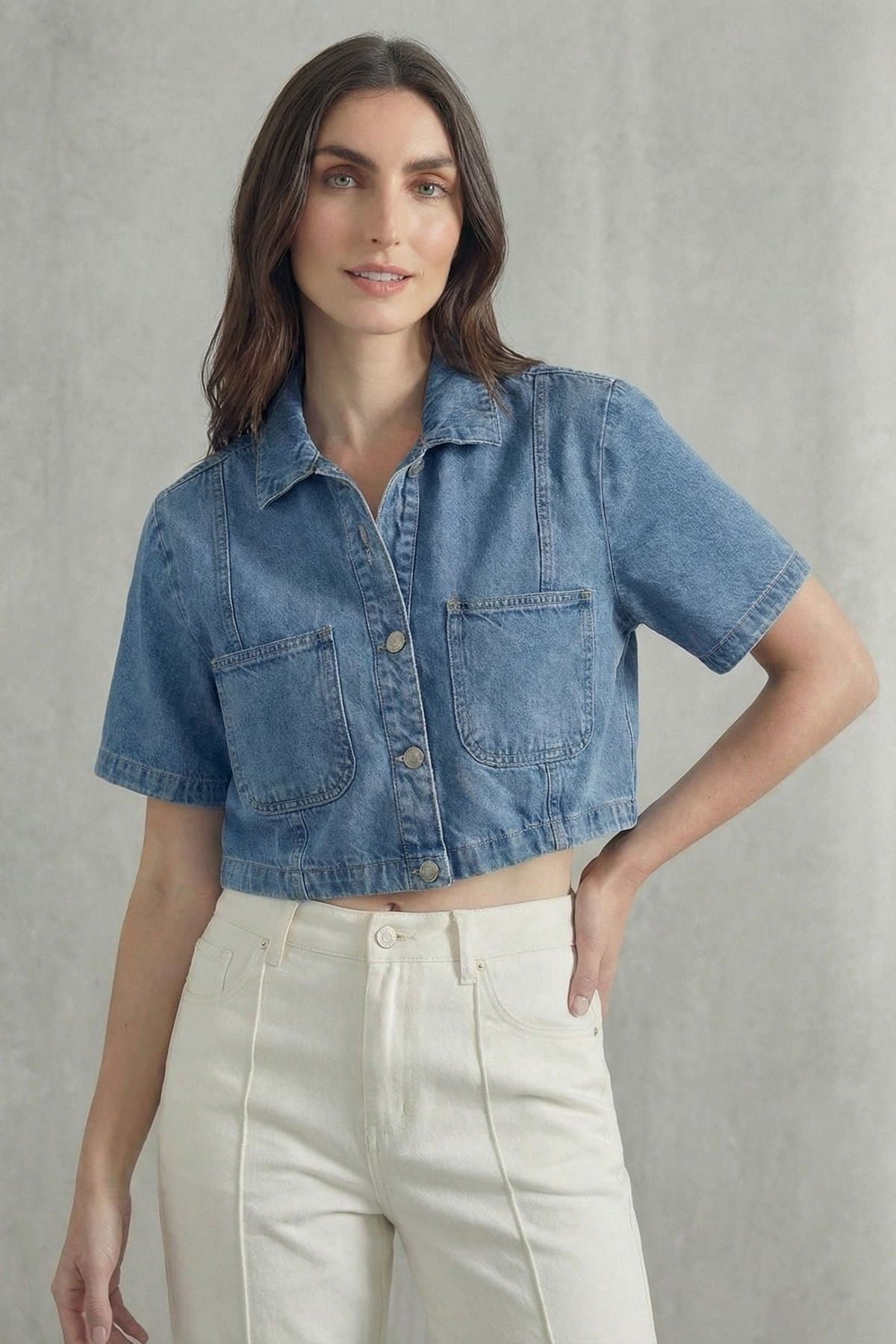 Female model in a light-blue cropped denim shirt