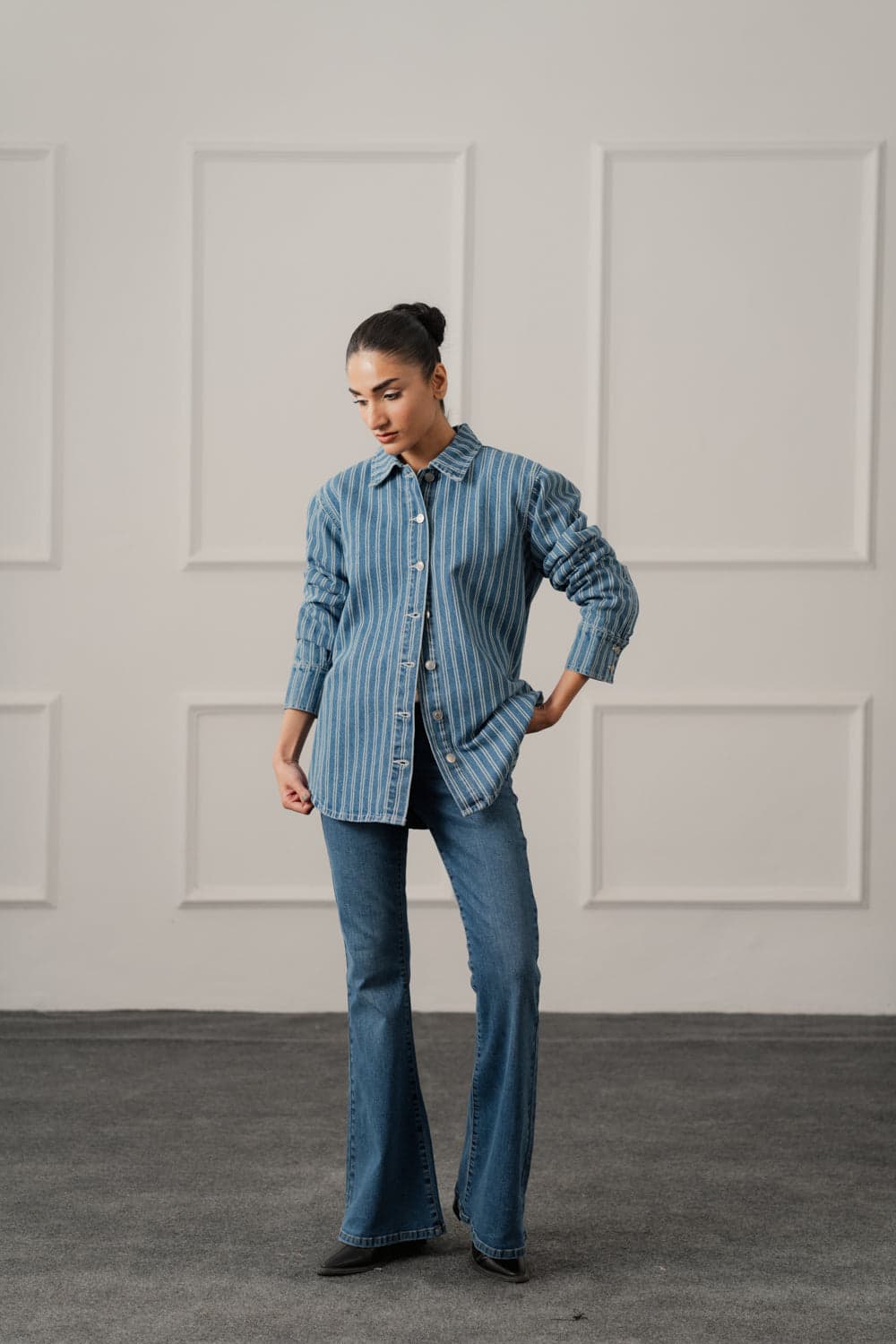 Female model in a blue striped relaxed denim over shirt