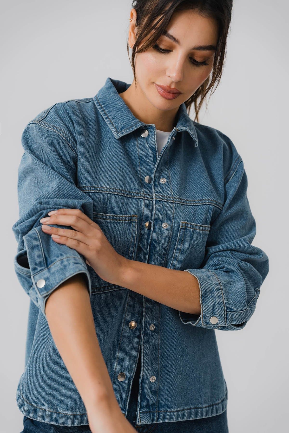 Female model in a classic blue denim jacket