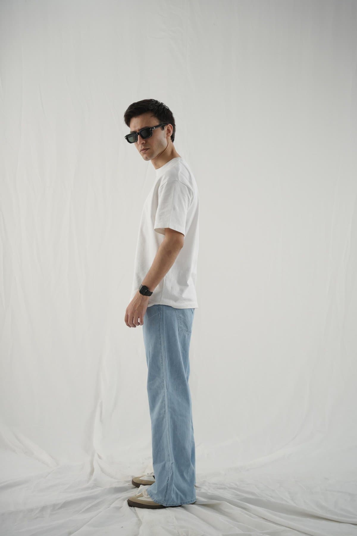 Ice-blue wide-leg jeans on a male model