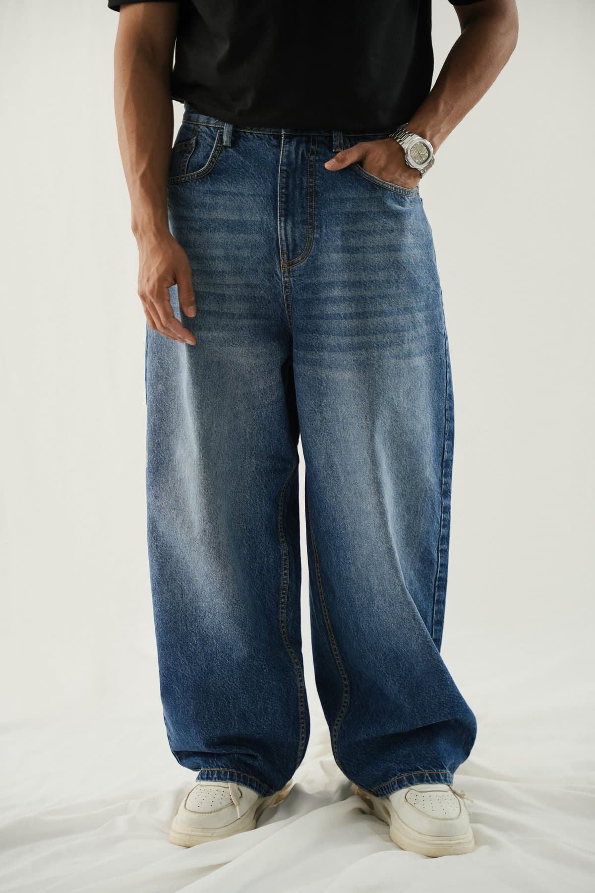 Dark-blue extra-baggy jeans on a male model