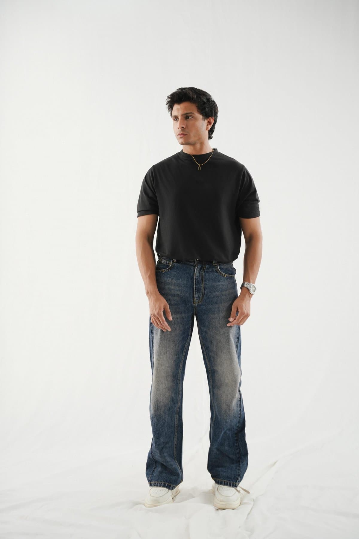 Loose-fit dark-blue jeans on a male model