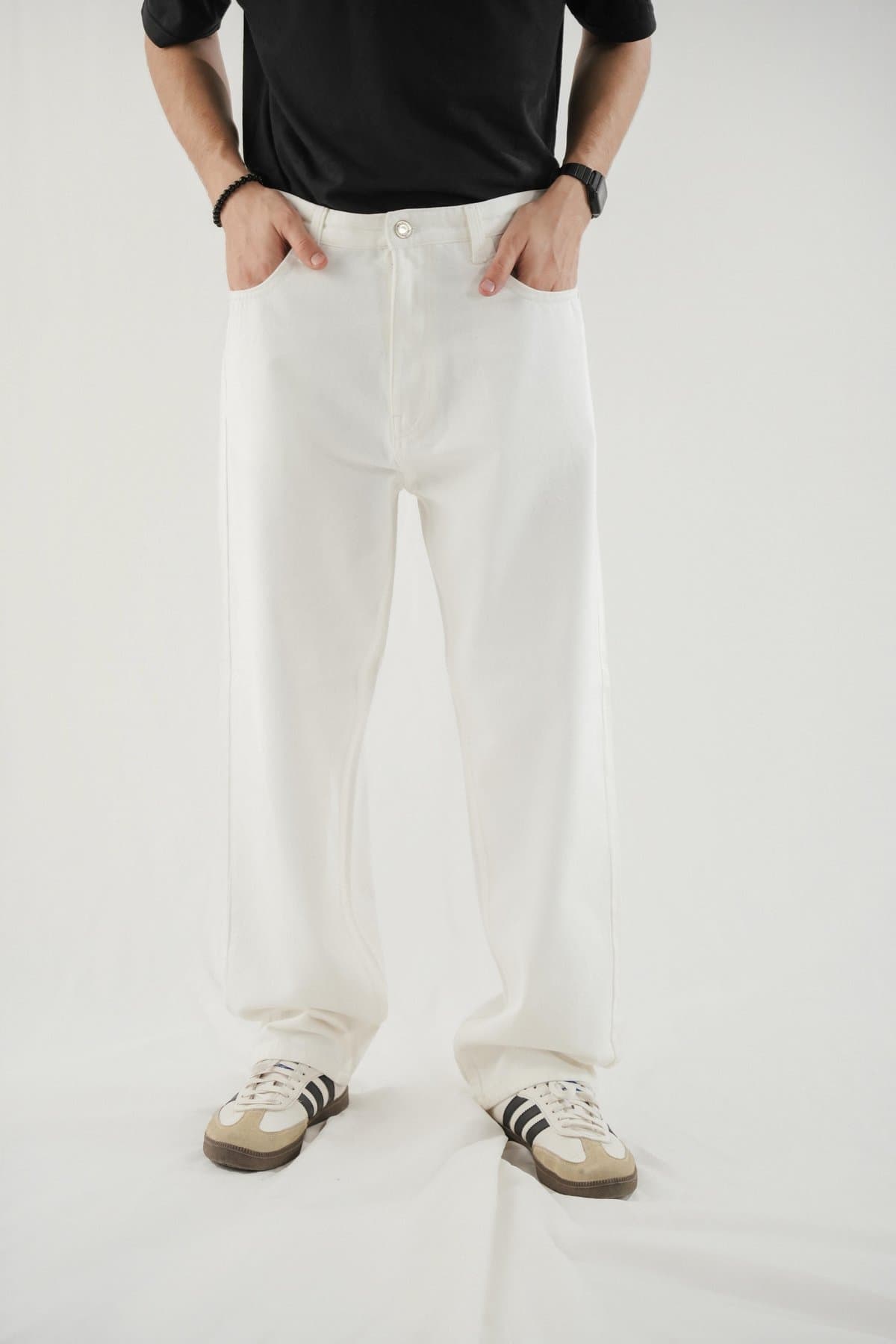 Cream baggy jeans on a male model