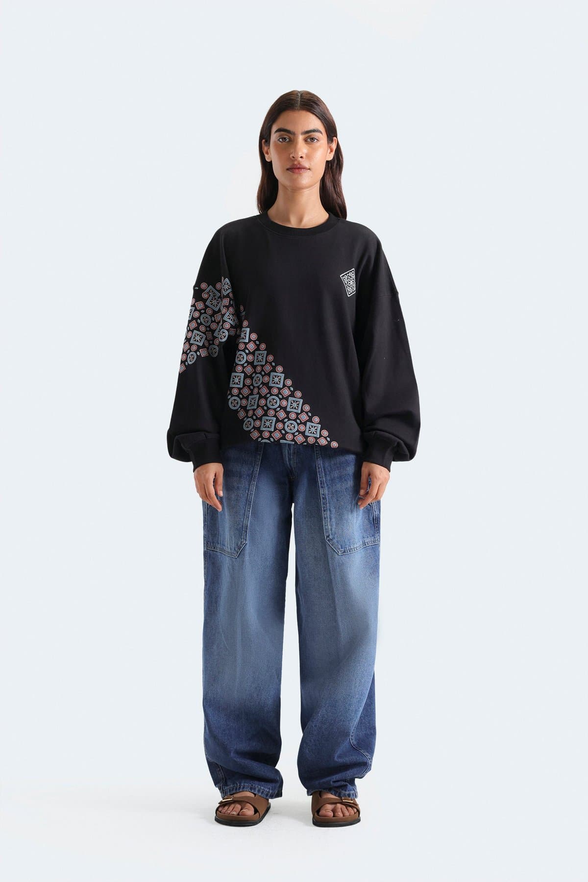 Female model in mid-blue wide-leg pleated jeans
