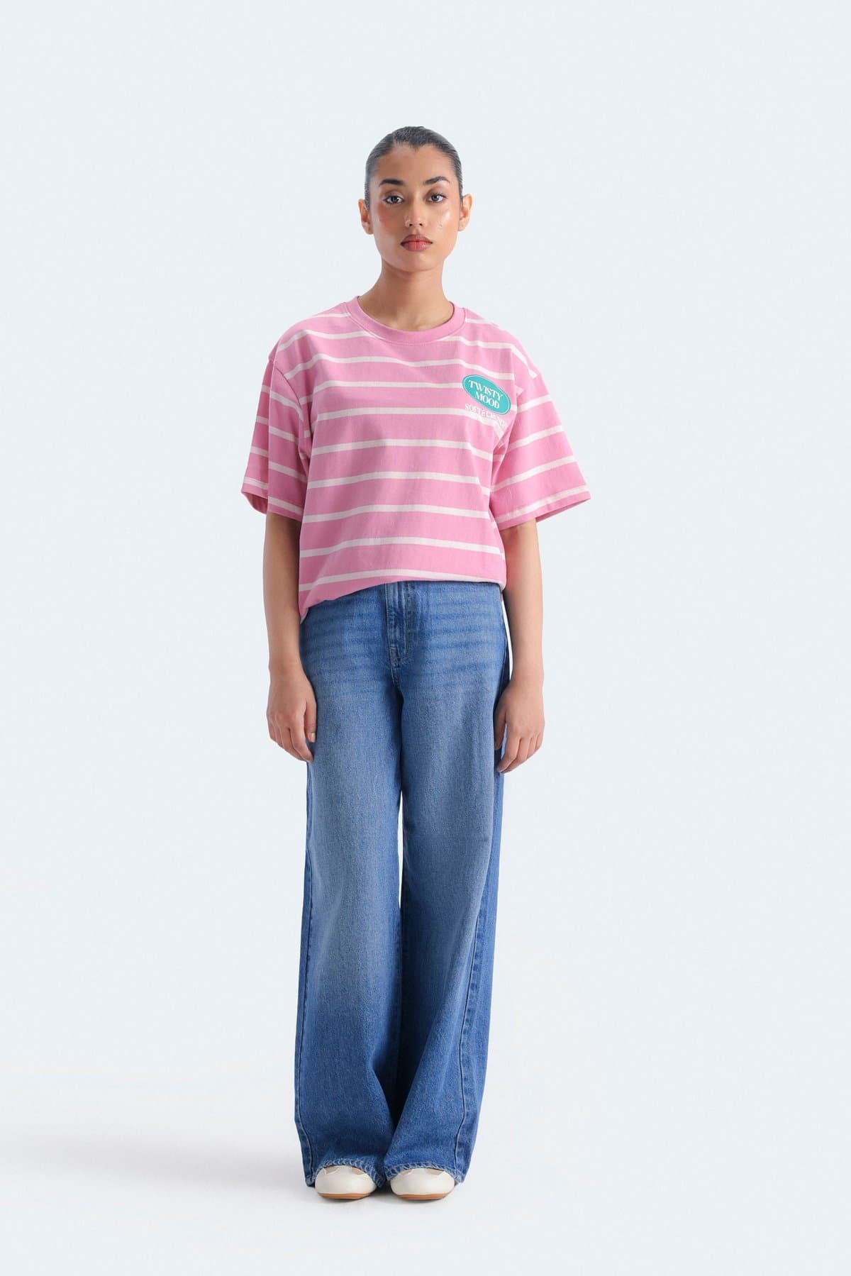 Female model in mid-blue wide-leg jeans