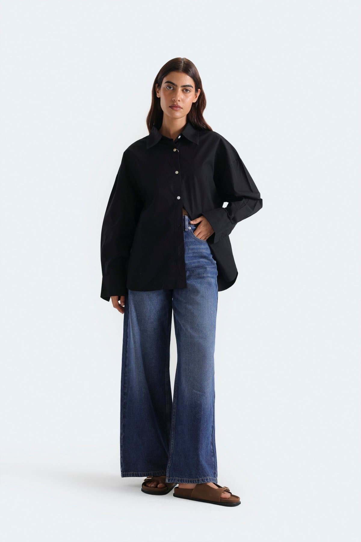 Female model in indigo wide-leg jeans