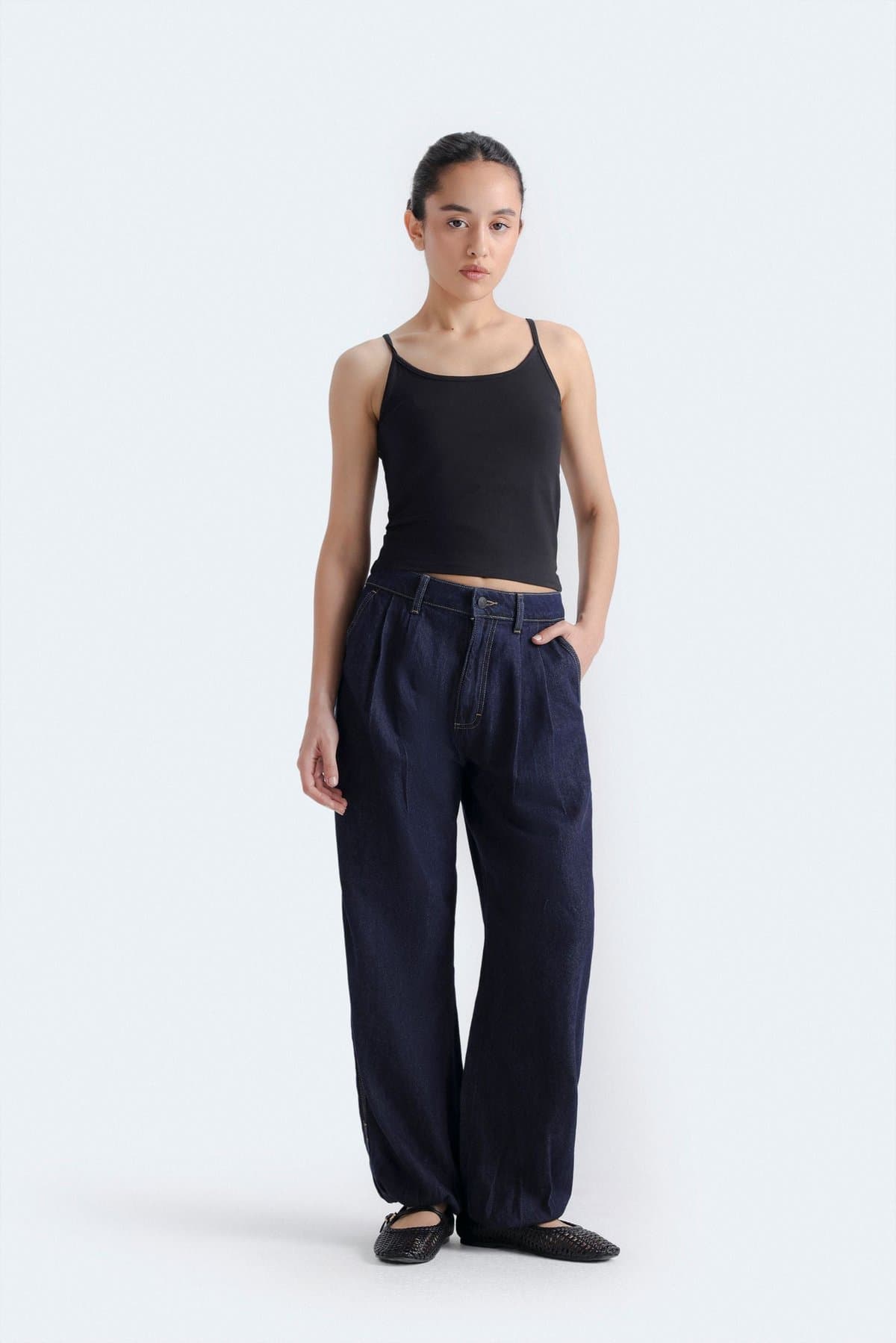 Female model in mid-blue balloon-fit jeans