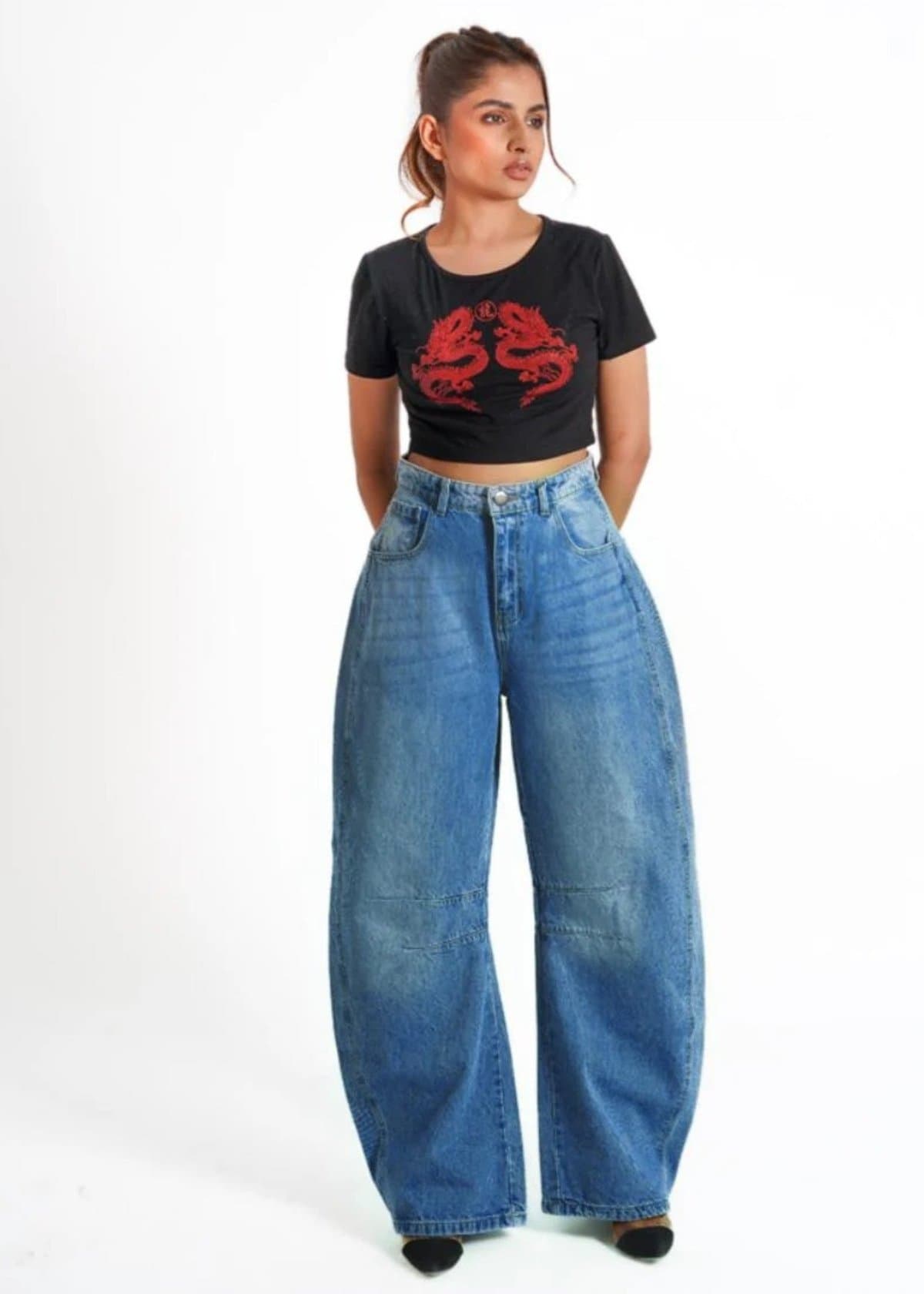 Female model in mid-blue baggy jeans