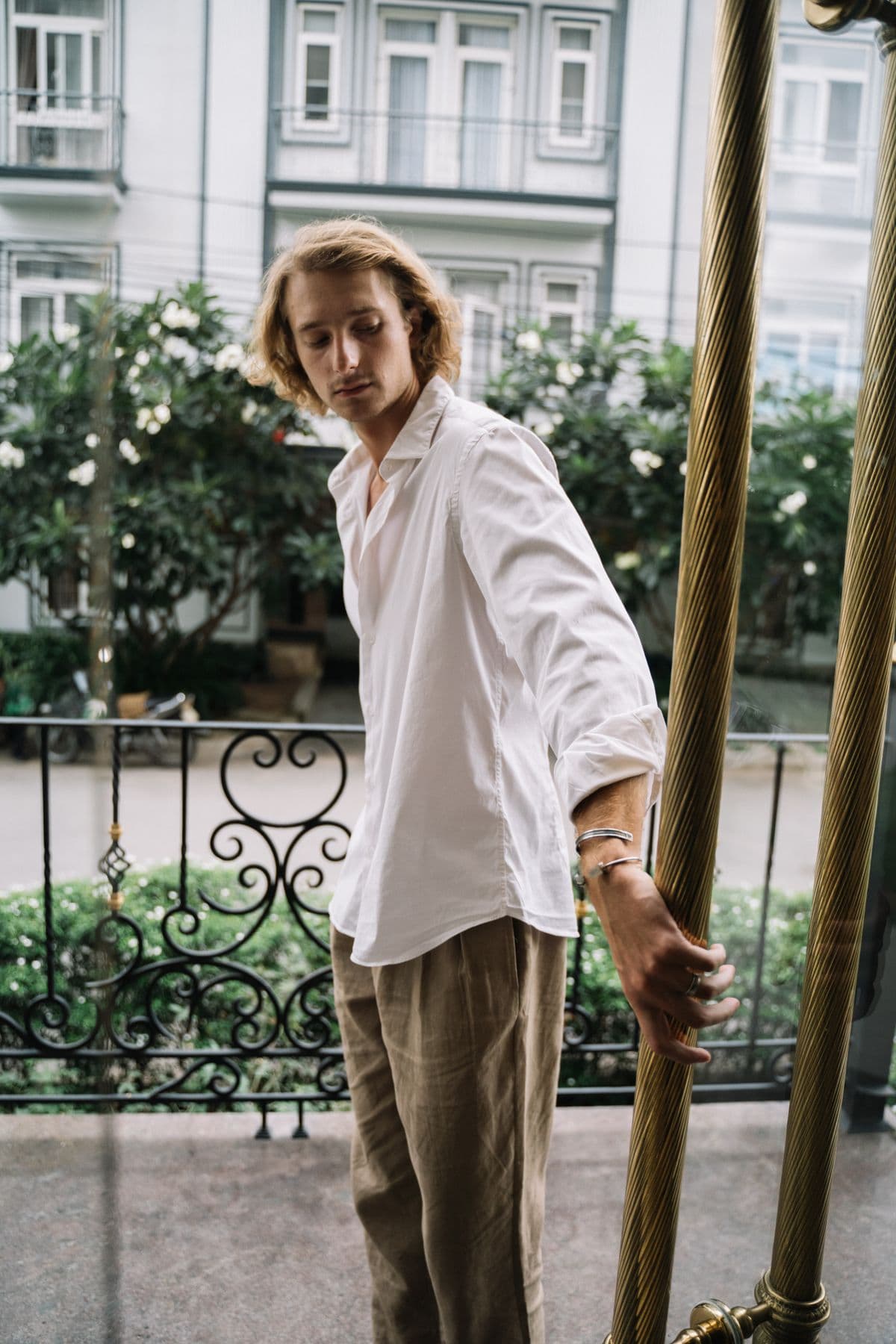 Male model in beige tailored linen trousers and a white shirt
