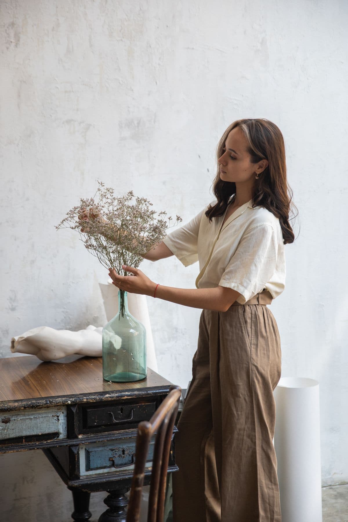 Female model in taupe wide-leg linen trousers