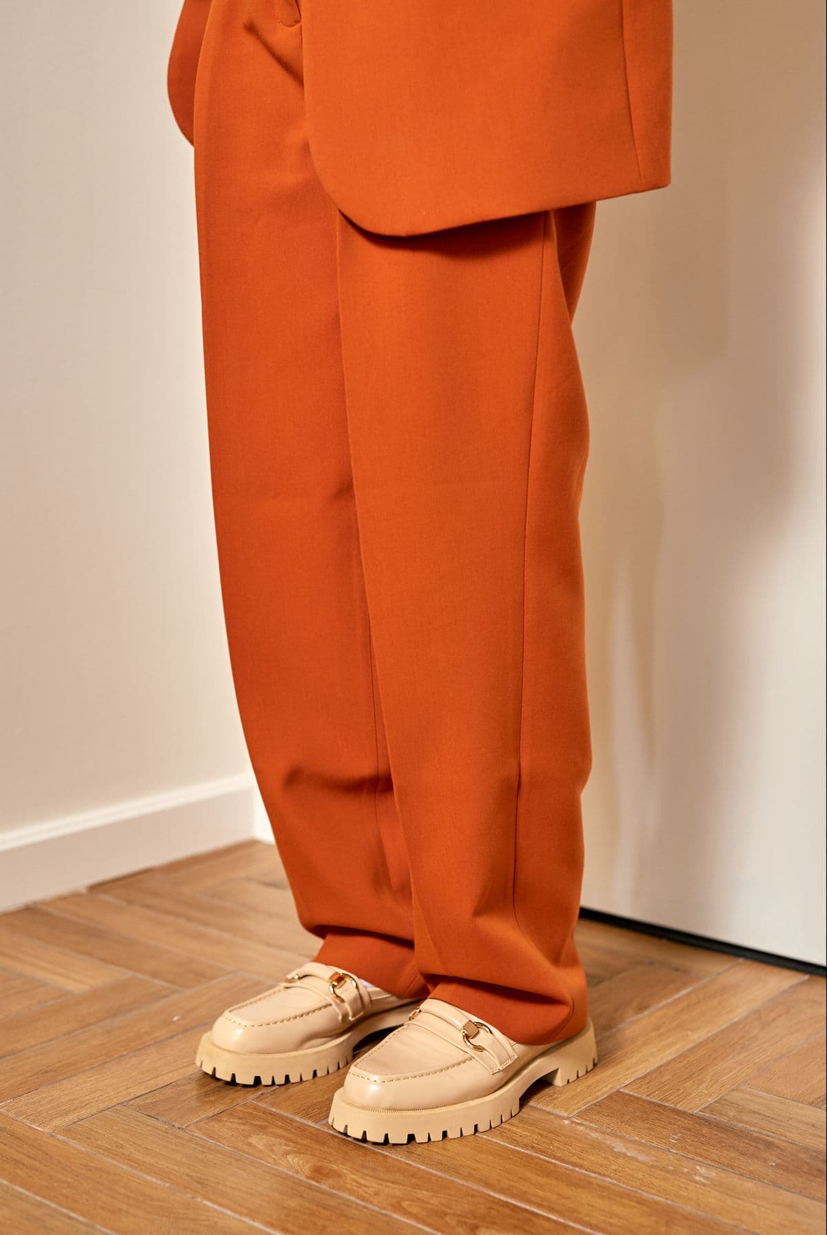 Female model in white wide-leg woven trousers
