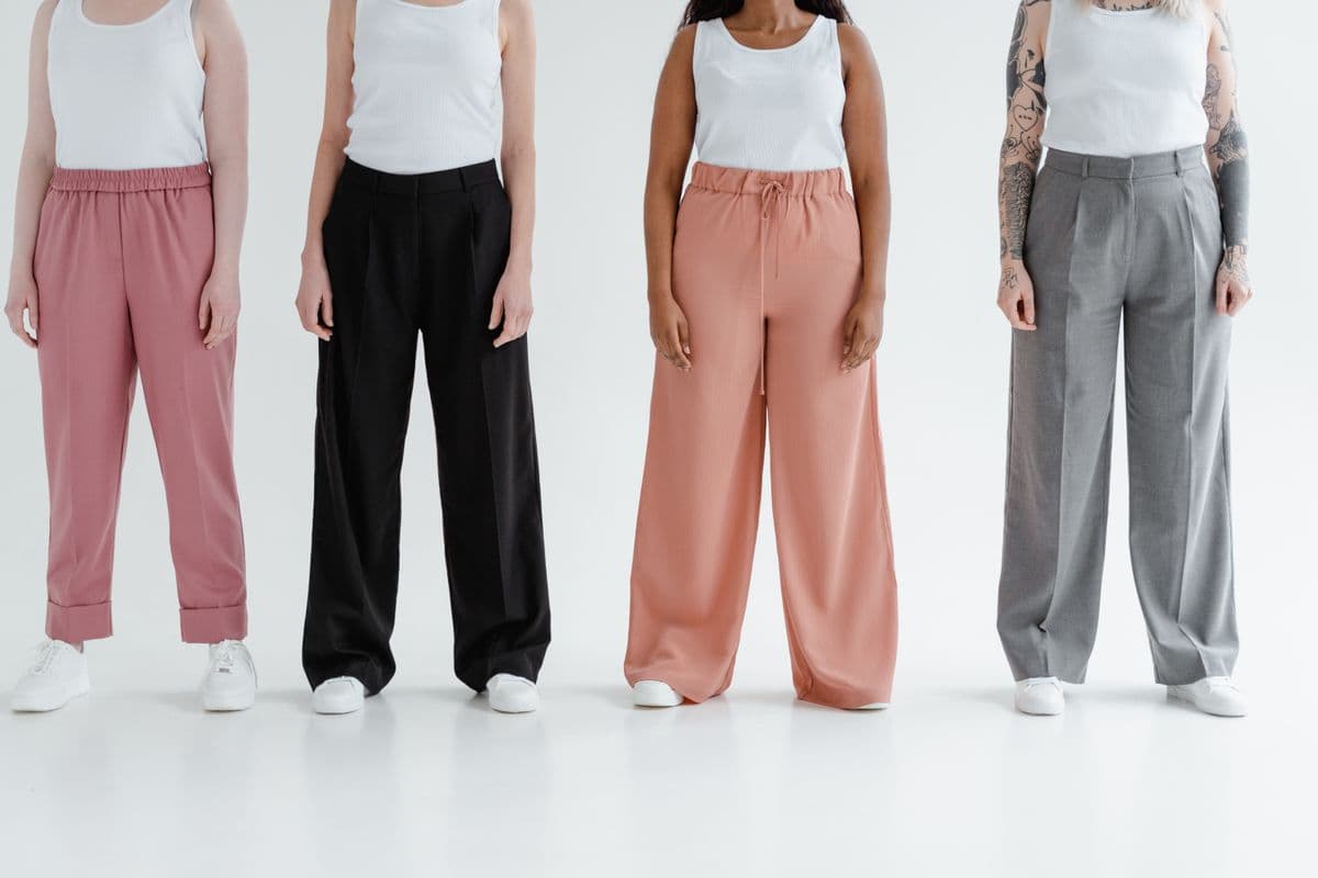 Tailored pleated woven trousers in soft neutral tones