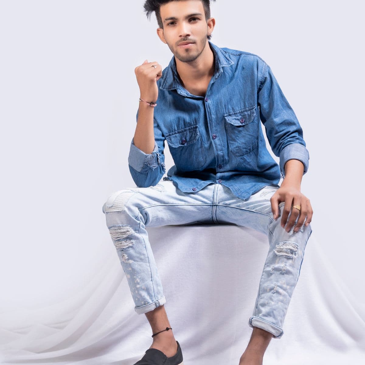 Man in a blue chambray shirt and light-wash jeans