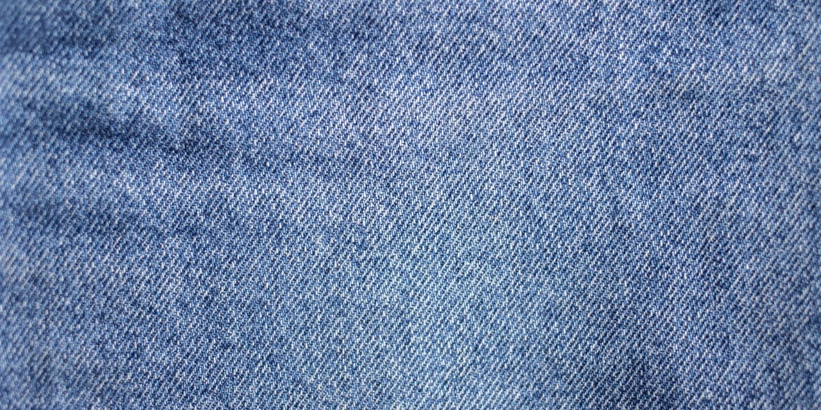 Mid-blue denim fabric and weave in close detail