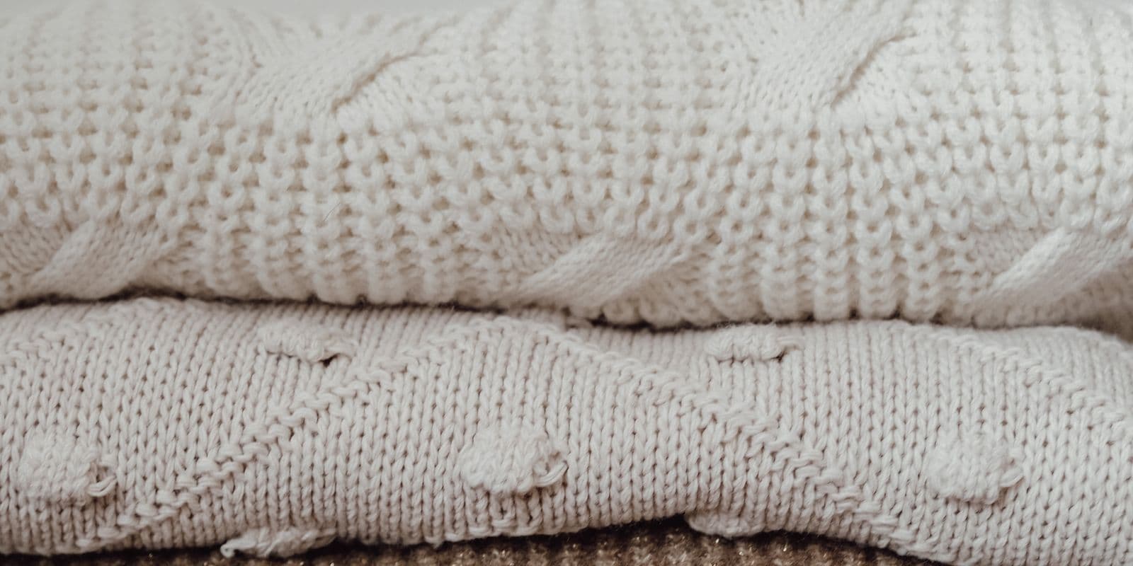 A folded stack of cream and oatmeal cotton basics