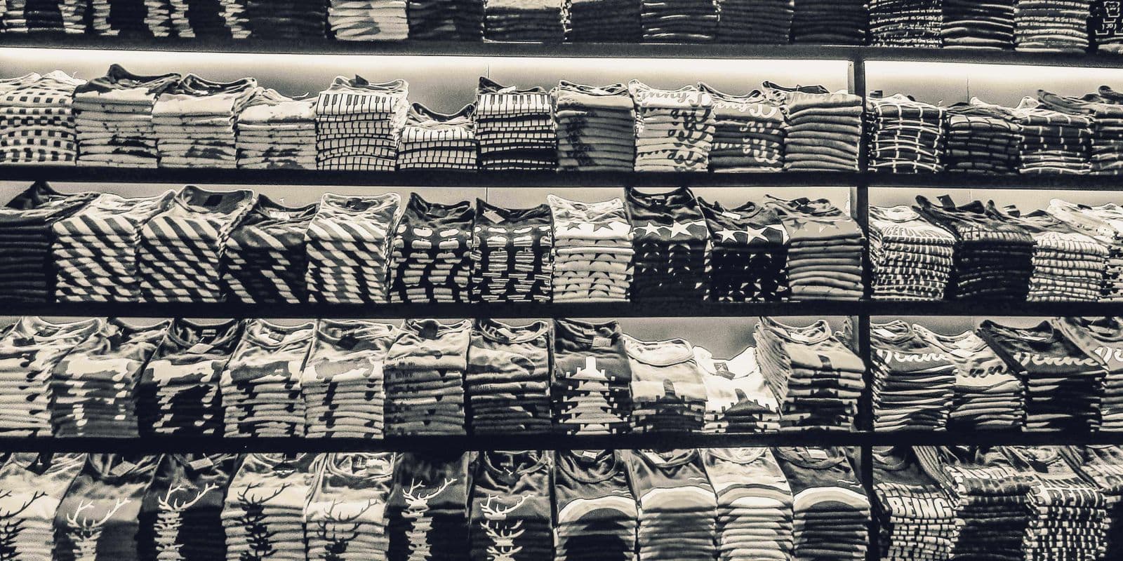 Neatly folded tees stacked on shelves