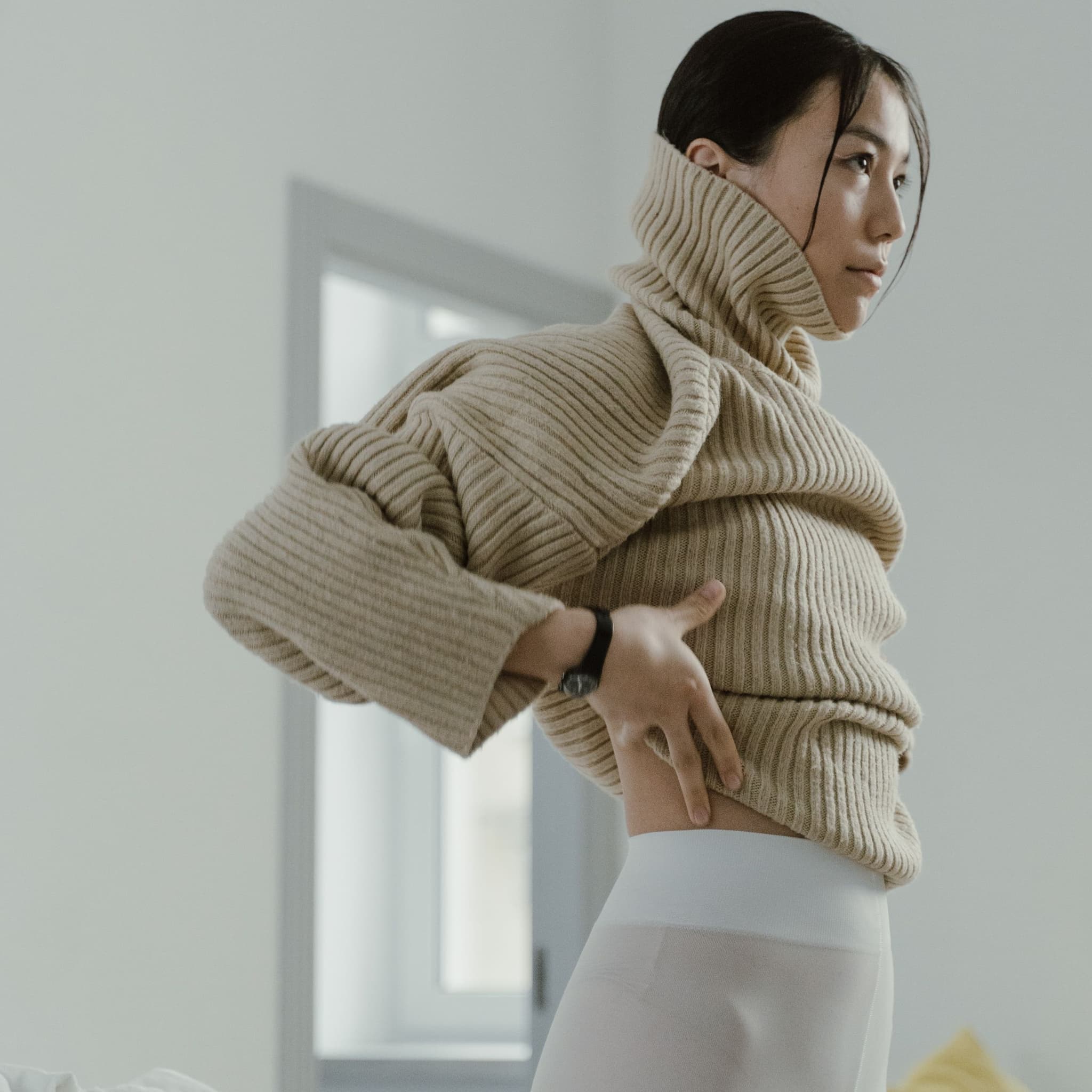 Woman in an oatmeal ribbed turtleneck