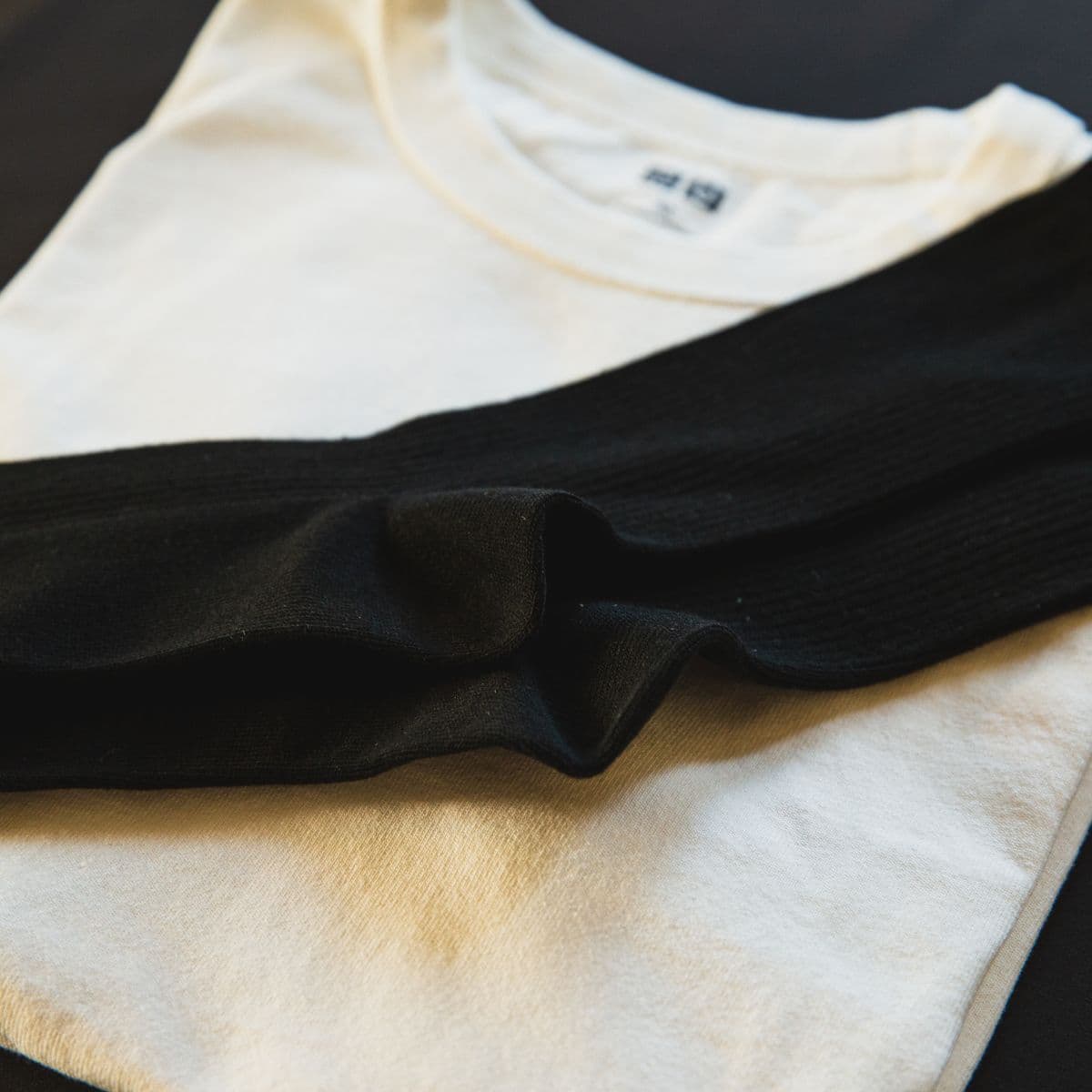 Folded black and ivory cotton tees
