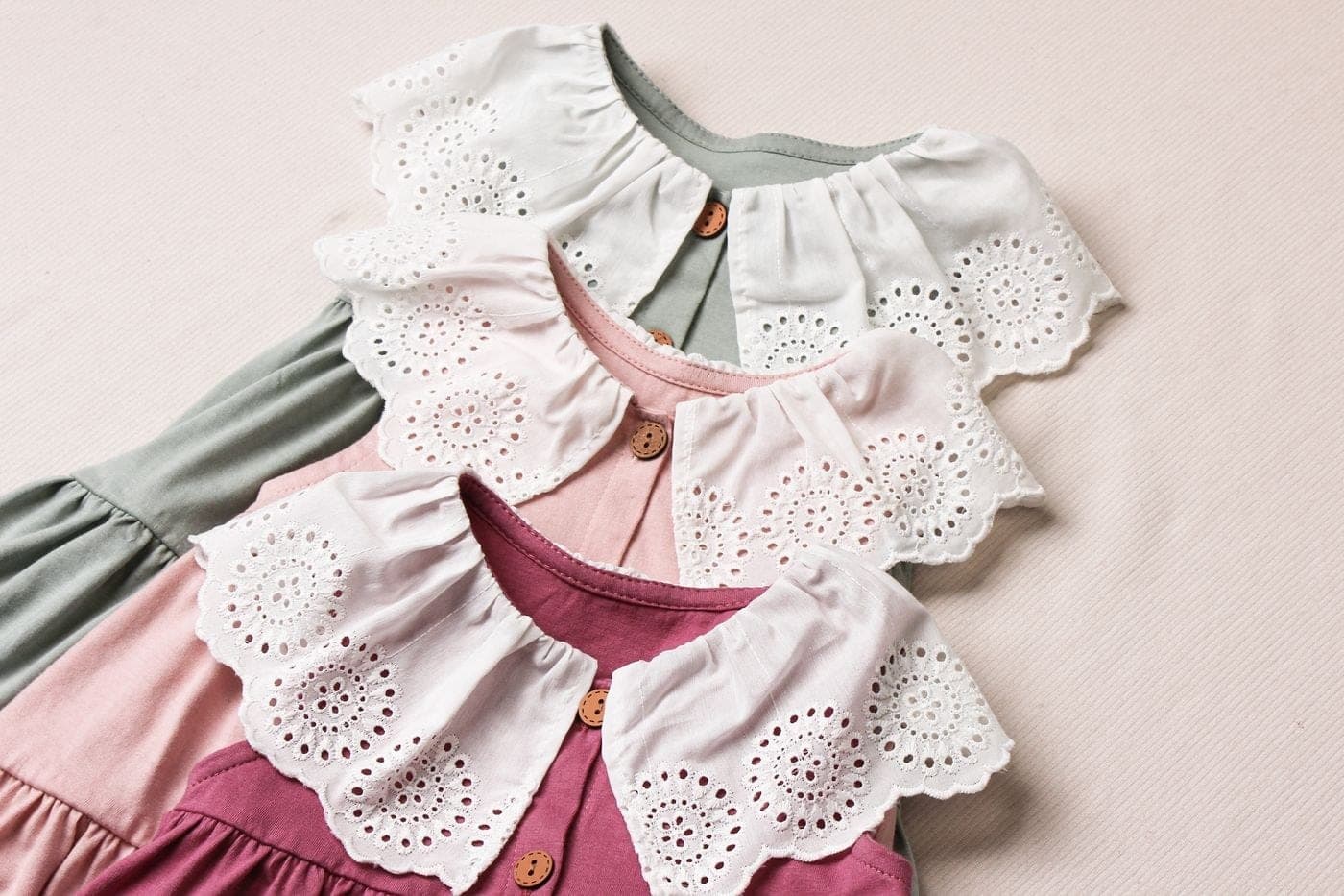 Delicate white lace-collar baby dresses