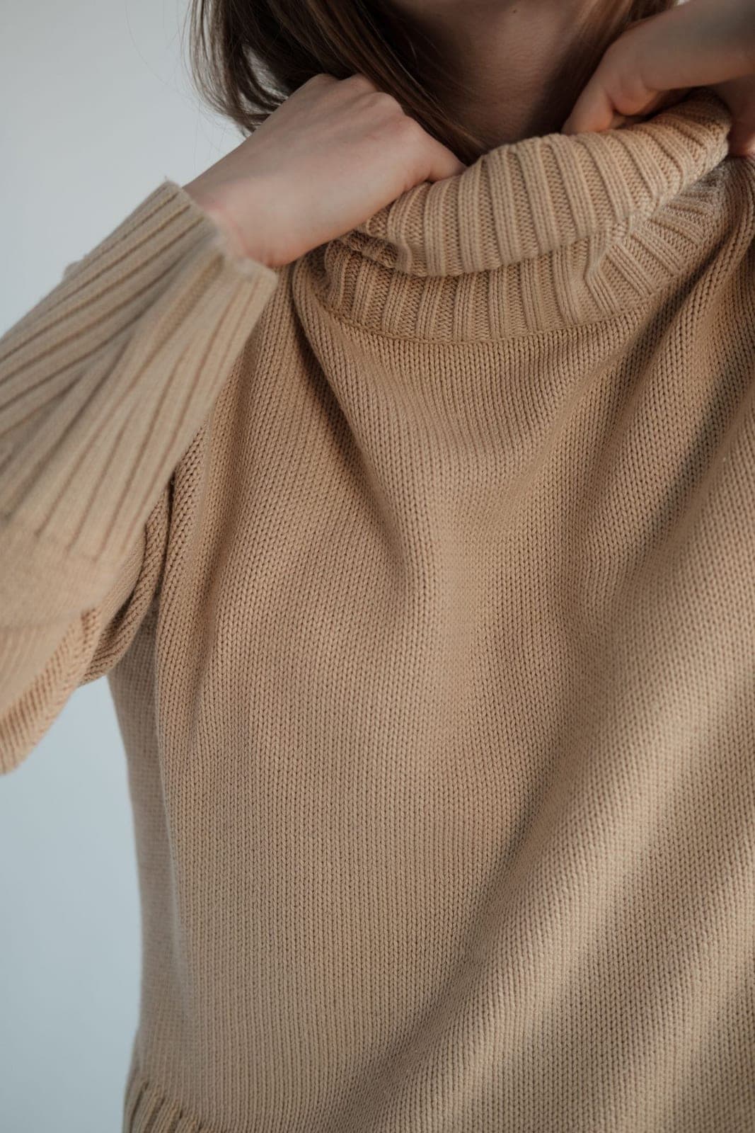 A soft beige roll-neck sweater