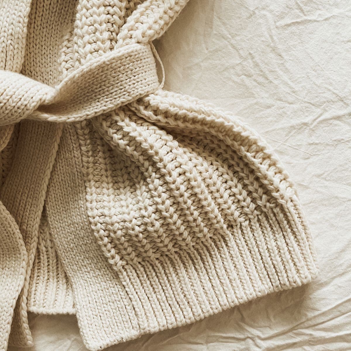 A single folded cream knit sweater