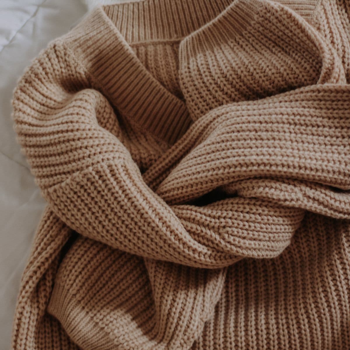 A rolled camel knit jumper