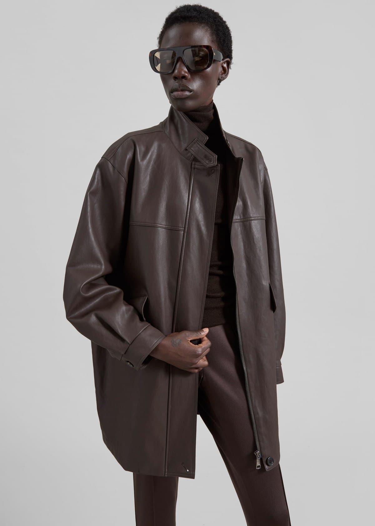 Model in a long brown leather jacket