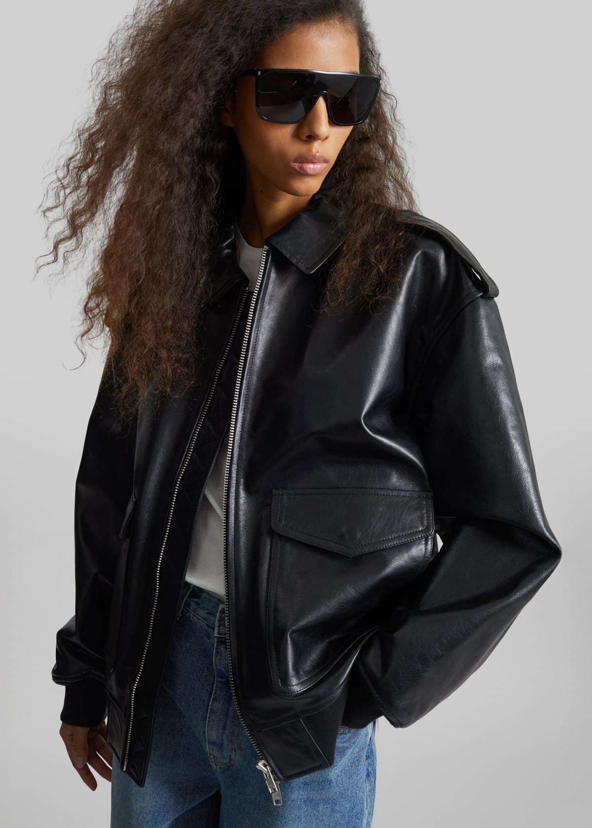 Model in a black oversized leather jacket