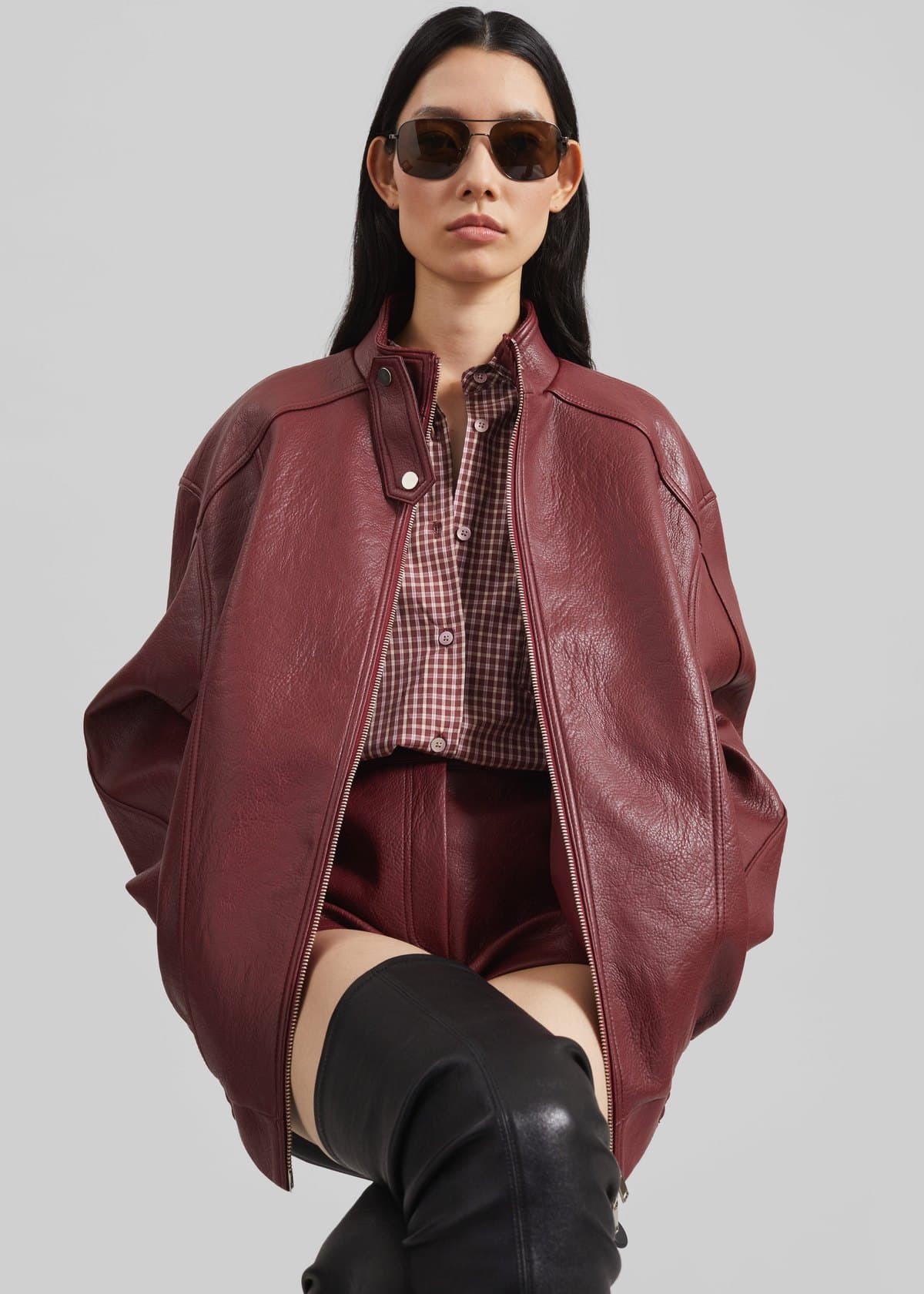Model in a burgundy leather bomber jacket