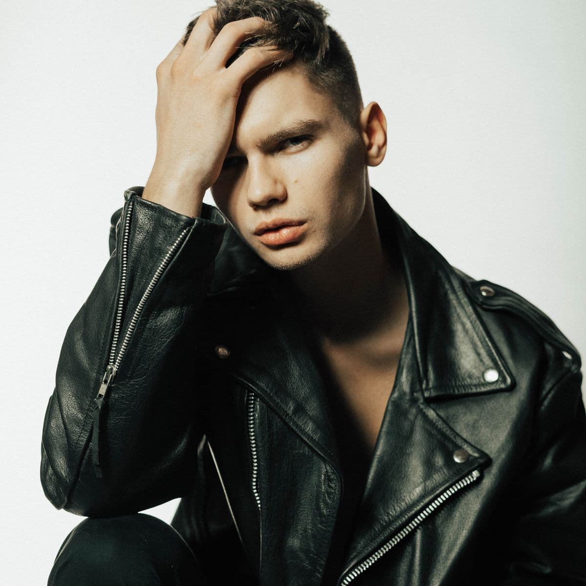 Man in a black leather moto jacket