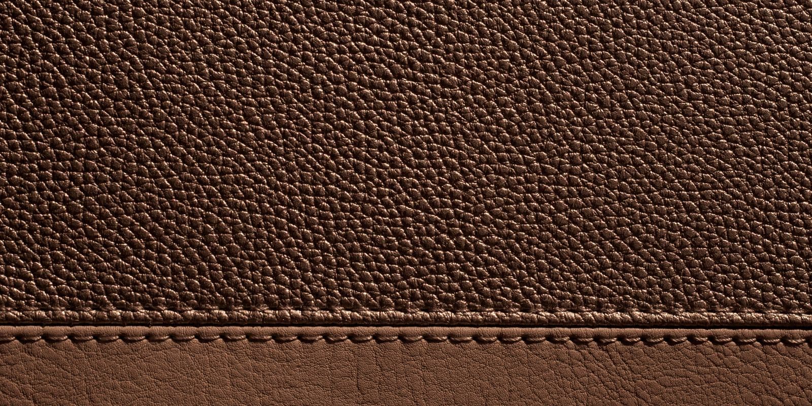 Brown pebbled leather grain with a stitched seam