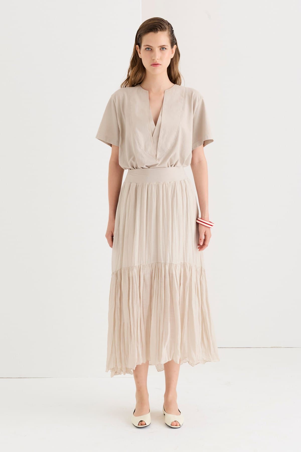 Model in a beige tiered cotton-voile maxi skirt